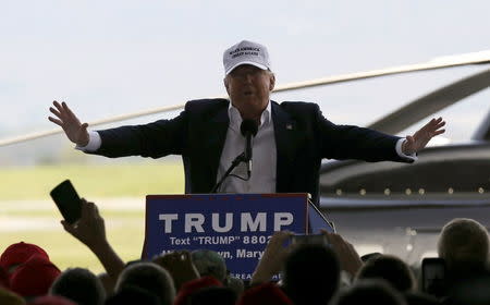 Republican U.S. presidential candidate Donald Trump speaks in front of his personal helicopter at a campaign rally in an airport hangar two days before the Maryland presidential primary election at the airport in Hagerstown, Maryland, U.S. April 24, 2016. REUTERS/Jim Bourg