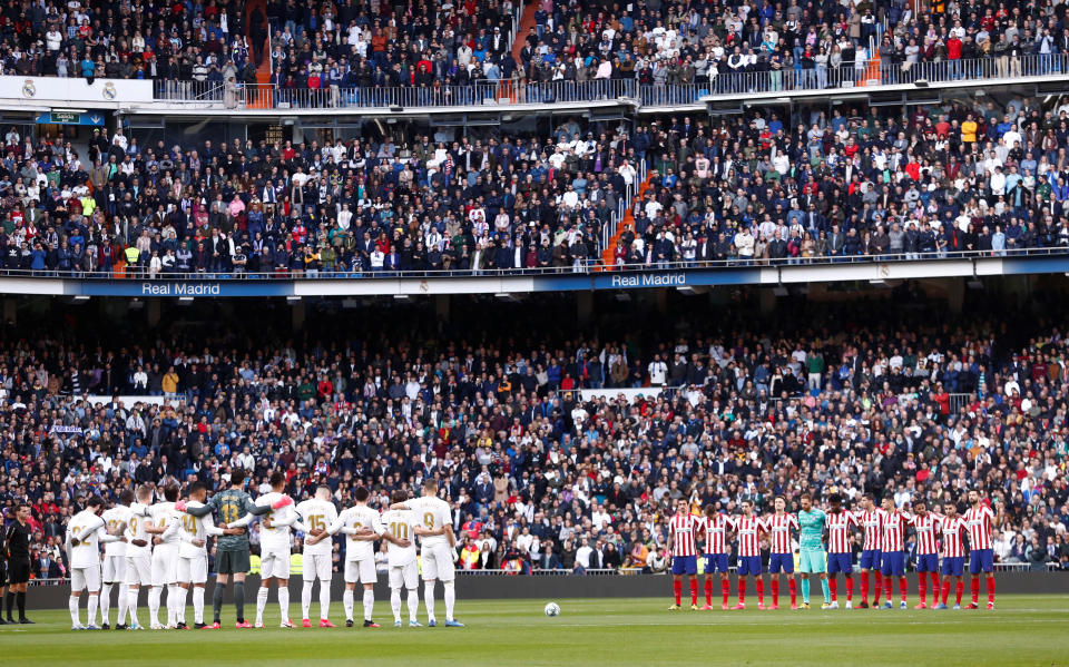 Real Madrid and Atletico Madrid stand at the center circle during a moment of silence in honor of Kobe Bryant. (REUTERS/Juan Medina)