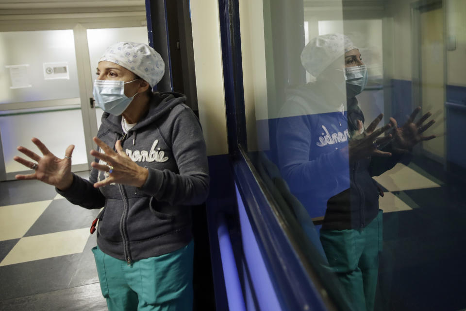 Nurse Cristina Settembrese talks during an interview with the Associated Press outside the intensive care unit after finishing a night shift, at the San Paolo hospital, in Milan, Italy, Thursday, Oct. 15, 2020. (AP Photo/Luca Bruno)