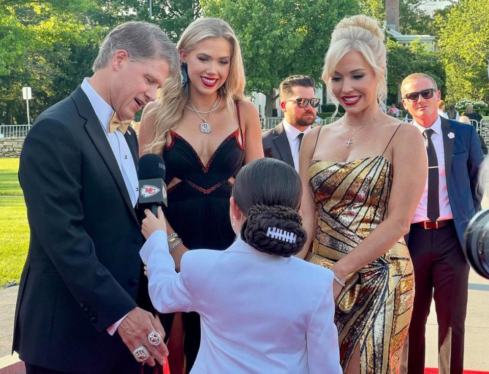 Kansas City Chiefs chairman and CEO Clark Hunt, with his daughter Gracie, center, and his wife, Tavia Shackles, talk with a reporter Thursday, June 13, 2024, during the Kansas City Chiefs Super Bowl LVIII Championship ring ceremony red carpet event at the Nelson-Atkins Museum of Art.