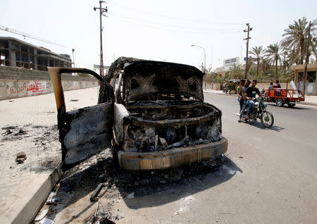 A burnt ambulance belonging to Iraq's Popular Mobilization Forces, burned during the protests, is seen in the street in Basra, Iraq September 8, 2018. REUTERS/Essam al-Sudani