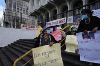 Women identified as victims of human rights violations during Guatemala's civil war, and their supporters, gather outside the Supreme Court in Guatemala City, Monday, Jan. 24, 2022. A decision at another court nearby is expected on Monday in the trial of five former civil defense patrolmen who fought alongside soldiers as civilians who are accused of sexual assault and human rights violations against dozens of Indigenous women from the Mayan Achi ethnic group. (AP Photo/Moises Castillo)