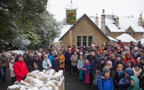 Locals gathered to celebrate its reopening - Credit: SWNS.com