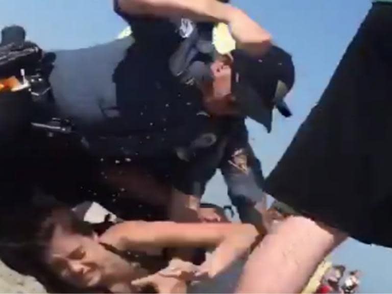 Investigation launched after police officer filmed punching woman on beach