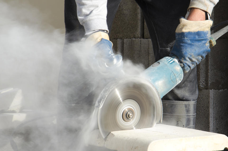 One common way construction workers are exposed to dust is through cutting building materials. (Photo: Getty Creative)