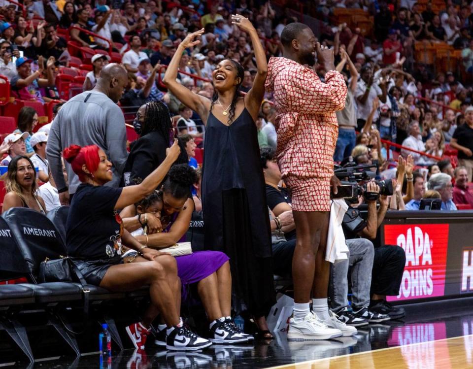 Former Miami Heat player Dwyane Wade and his wife Gabrielle Union cheer on Udonis Haslem during the first quarter of an NBA game against the Orlando Magic at Kaseya Center in Downtown Miami, Florida, on Sunday, April 9, 2023.