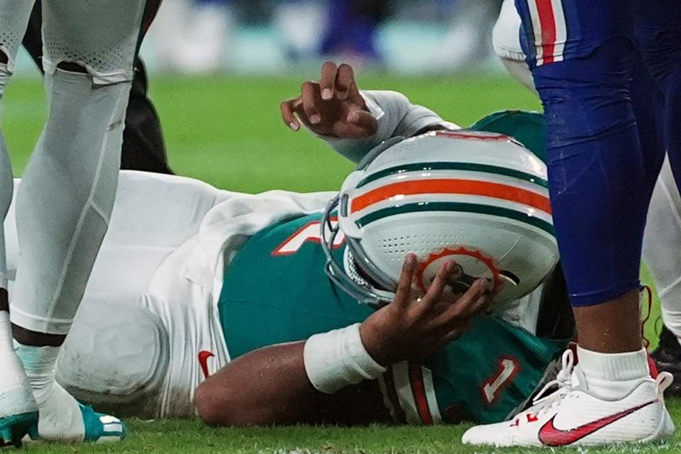 Sep 12, 2024; Miami Gardens, Florida, USA; Miami Dolphins quarterback Tua Tagovailoa (1) sufferes an apparent concussion after hitting his head on the ground while being tackled by Buffalo Bills safety Damar Hamlin (3) during the second half at Hard Rock Stadium. Mandatory Credit: Jasen Vinlove-Imagn Images