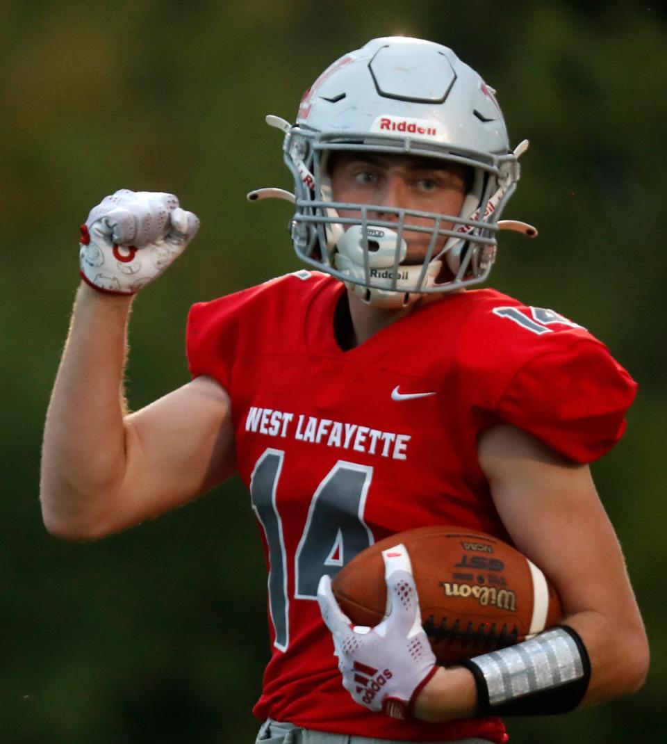 West Lafayette Red Devils Cooper Kitchel (14) celebrates after scoring a touchdown during the IHSAA football game against the Western Panthers, Friday, Sept. 2, 2022, at Gordon Straley Field in West Lafayette, Ind. 