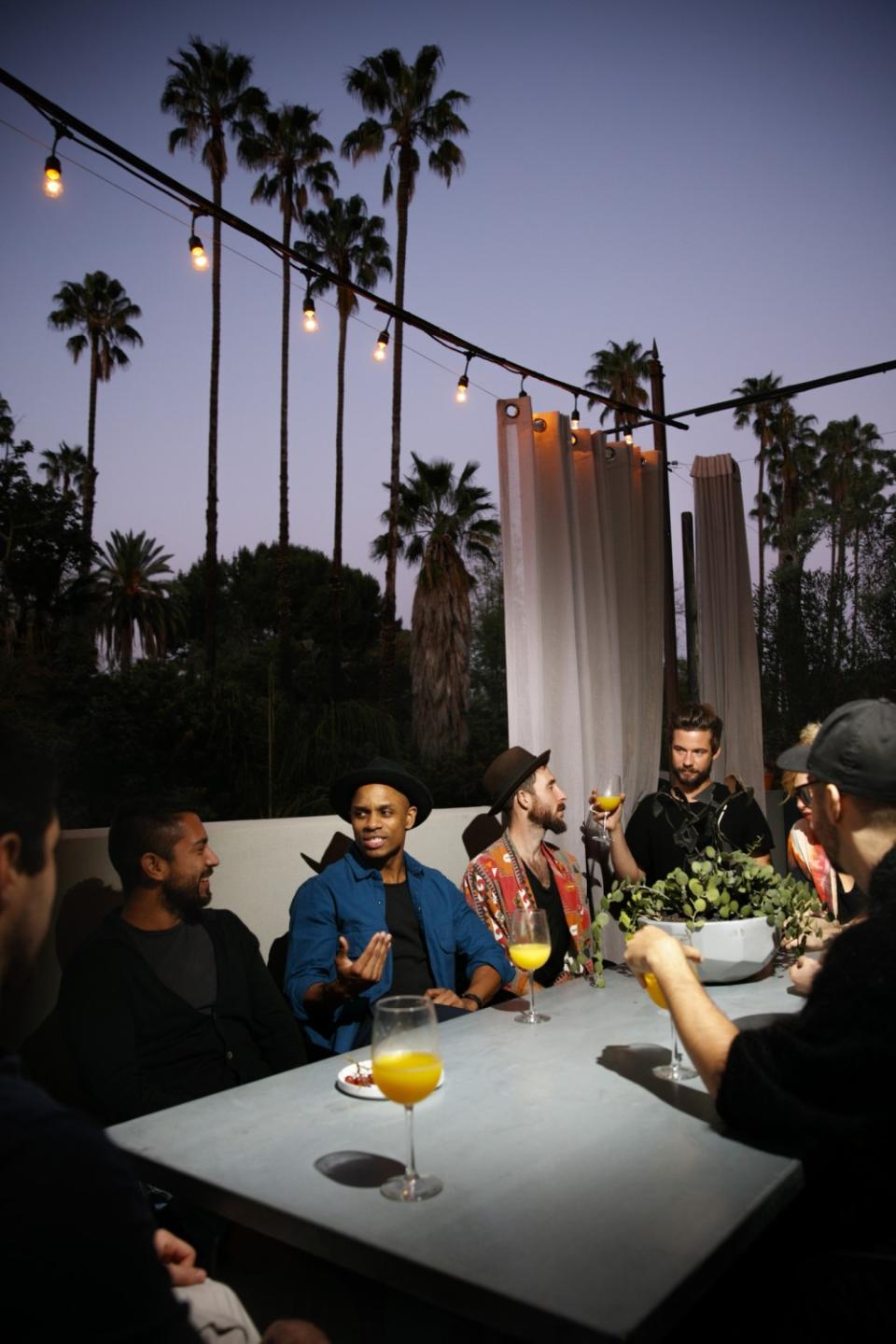 Matty Pipes and friends enjoy the outdoors beneath a simple string of lights in Hollywood.