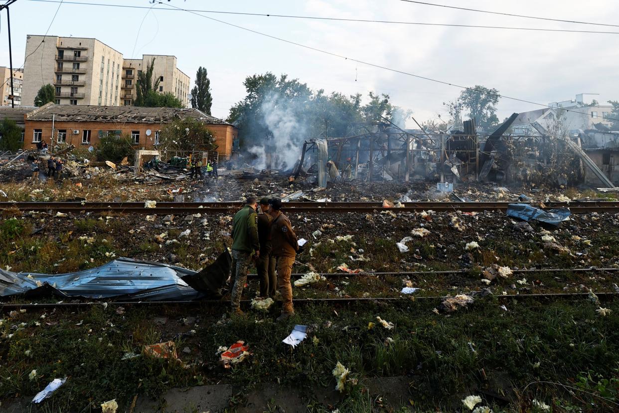 Emergency services stand at a site in a residential area damaged this morning (REUTERS)