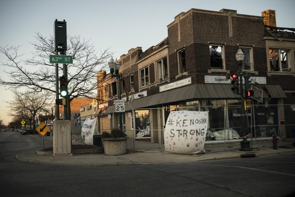 A banner which reads "Kenosha Strong" hangs on the facade of a building that was damaged during protests in Kenosha, Wis., Sunday, Nov. 1, 2020. The trouble in Kenosha began on Aug. 23 when a Kenosha police officer, responding to a call about a domestic dispute, was caught on video shooting Jacob Blake repeatedly in the back at close range. Blake, a Black man, survived but is partially paralyzed. The August shootings have spurred a spike in political involvement in Kenosha, with the formation of activism and waves of new voters signing up. (AP Photo/Wong Maye-E)