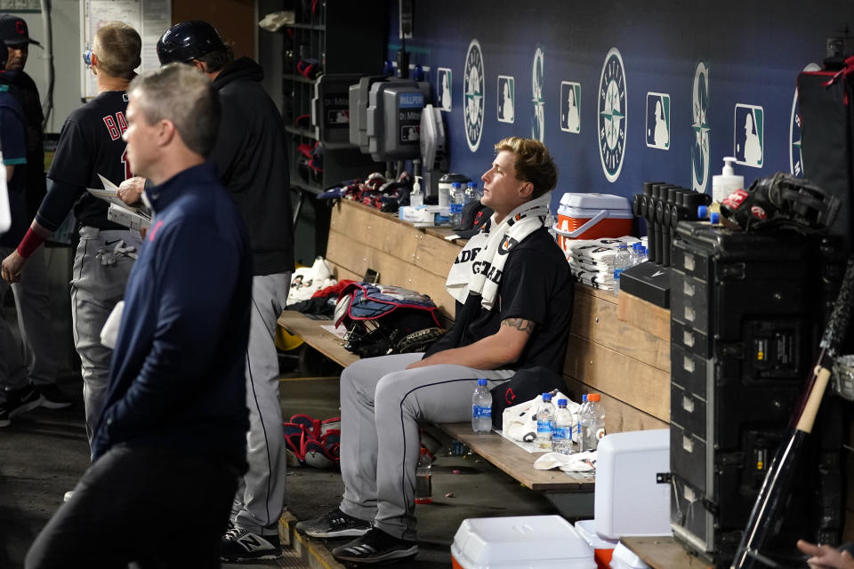 Cleveland Indians starting pitcher Zach Plesac sits in the dugout after the sixth inning of the team's baseball game against the Seattle Mariners on Thursday, May 13, 2021, in Seattle. (AP Photo/Elaine Thompson)