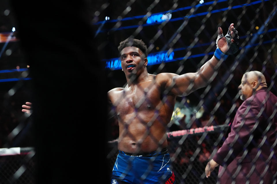 Jul 8, 2023; Las Vegas, Nevada, USA; Alonzo Menifield (blue gloves) reacts after defeating Jimmy Crute (red gloves) during UFC 290 at T-Mobile Arena. Mandatory Credit: Stephen R. Sylvanie-USA TODAY Sports