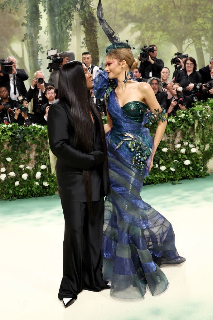 Law in a dark gown and Zendaya in a striped mermaid gown