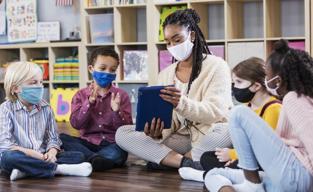 <span class="caption">Teachers have faced high levels of stress and burnout throughout the pandemic.</span> <span class="attribution"><a class="link " href="https://www.gettyimages.com/detail/photo/preschool-teacher-students-in-class-wearing-masks-royalty-free-image/1294218659" rel="nofollow noopener" target="_blank" data-ylk="slk:Kali9/E+ Collection via Getty Images;elm:context_link;itc:0;sec:content-canvas">Kali9/E+ Collection via Getty Images</a></span>