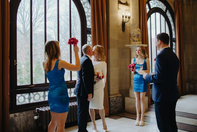 <p>Caroline Eyer</p> The newlyweds sharing a kiss on at their wedding at Memorial Hall.