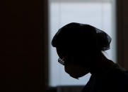 A healthcare worker silhouetted against the window, during a shift at an intensive care unit (ICU) at the General University Hospital where patients infected with the COVID-19 are treated in Prague, Czech Republic, Tuesday, April 7, 2020. The new coronavirus causes mild or moderate symptoms for most people, but for some, especially older adults and people with existing health problems, it can cause more severe illness or death. (AP Photo/Petr David Josek)