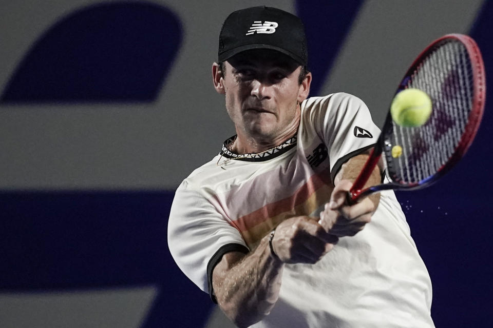 Tommy Paul of the United States hits a return to Alex de Minaur of Australia in the final match at the Mexican Open tennis tournament in Acapulco, Mexico, Saturday, March 4, 2023. (AP Photo/Eduardo Verdugo)