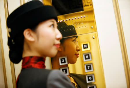 22-year-old elevator operator Yuria Nagamoto works at Takashimaya department store in Tokyo, Japan October 18, 2018. Picture taken October 18, 2018. REUTERS/Issei Kato