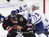 Toronto Maple Leafs defenseman Travis Dermott (23) defends against Ottawa Senators center Artem Anisimov (51) during the first period of an NHL hockey game Friday, Jan. 15, 2021, in Ottawa, Ontario. (Sean Kilpatrick/The Canadian Press via AP)