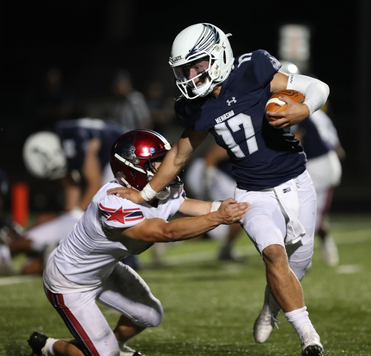 Menasha's AJ Korth (17) runs for yardage against Appleton East during their football game Friday in Menasha.