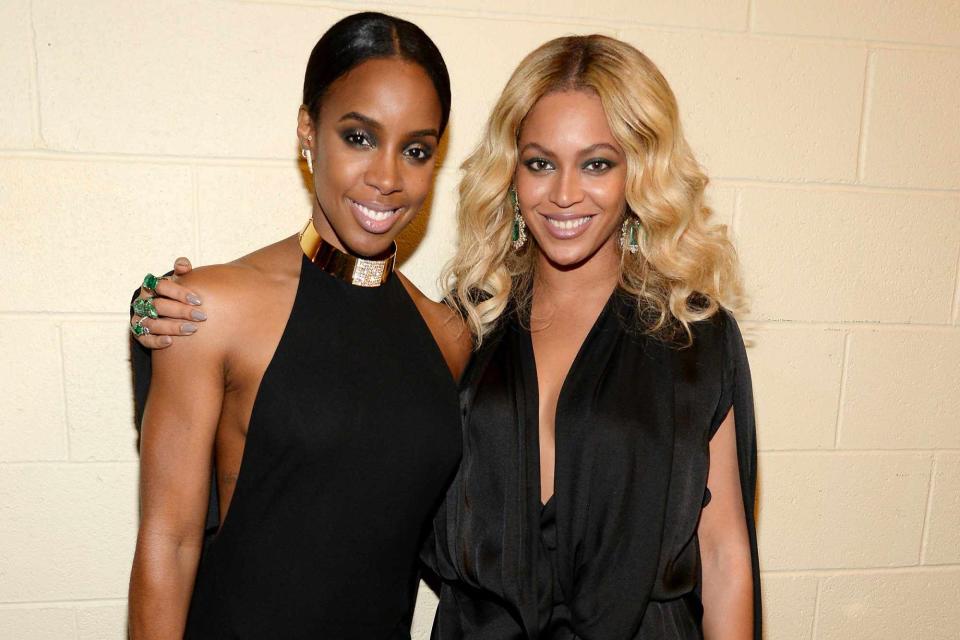 Kevin Mazur/Getty Kelly Rowland and Beyonce Knowles smiling