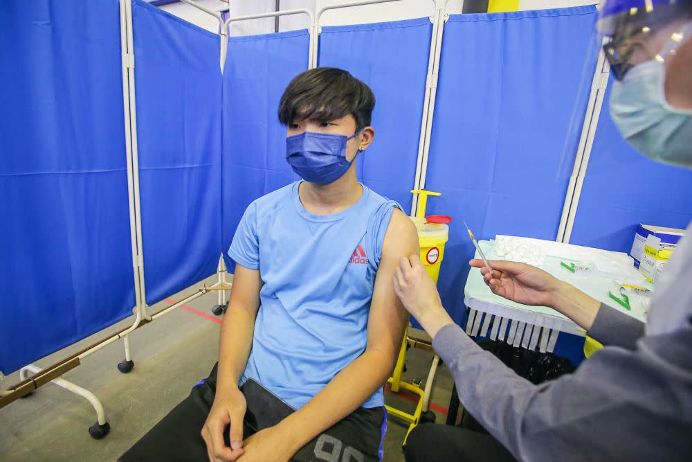 A student receives his Covid-19 jab at the Kinta Town Hall in Batu Gajah September 21, 2021. — Picture by Farhan Najib