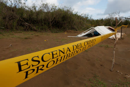 A police cordon marks the perimeter of the site where a forensic team and judicial authorities work in unmarked graves where skulls were found, on the outskirts of Veracruz, Mexico March 16, 2017. REUTERS/Carlos Jasso