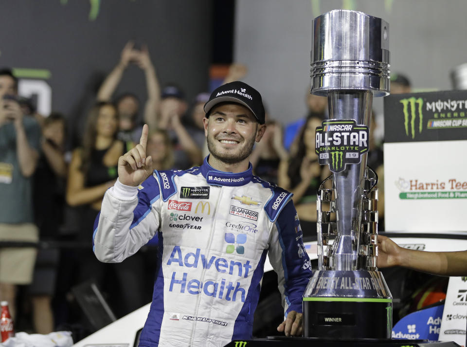 Kyle Larson poses with the trophy after winning the NASCAR All-Star Race at Charlotte Motor Speedway in Concord, N.C., Saturday, May 18, 2019. (AP Photo/Chuck Burton)