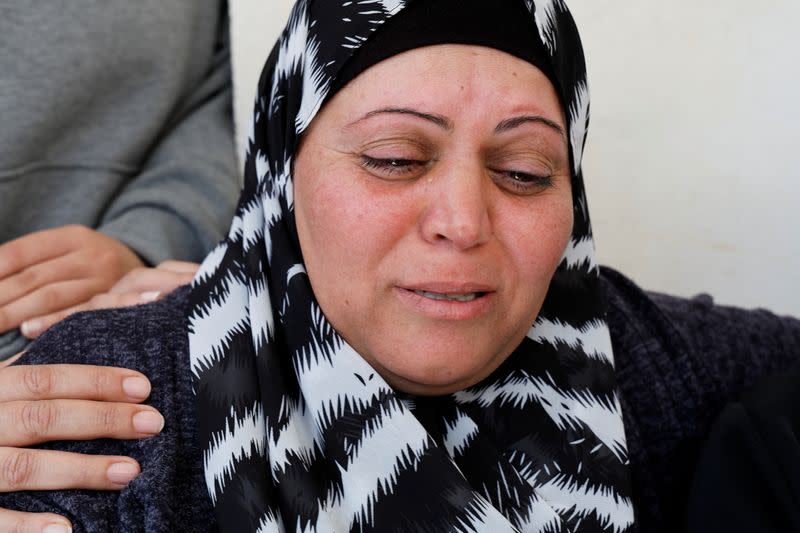 A family member of a Palestinian man killed by Israeli forces reacts, near Ramallah in the Israeli-occupied West Bank