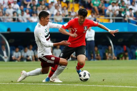 Soccer Football - World Cup - Group F - South Korea vs Mexico - Rostov Arena, Rostov-on-Don, Russia - June 23, 2018 South Korea's Son Heung-min in action with Mexico's Edson Alvarez REUTERS/Damir Sagolj