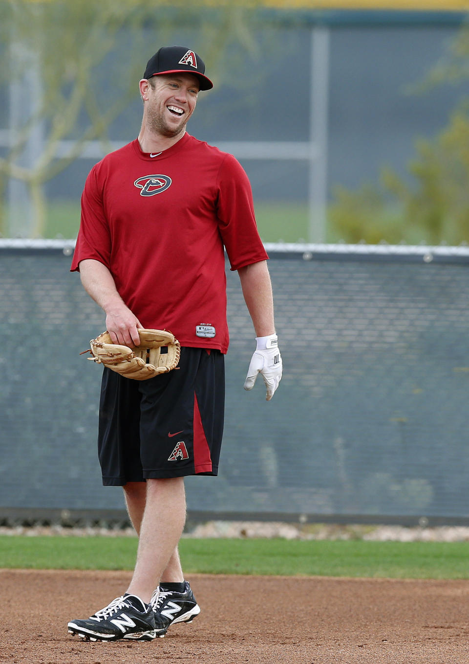 Arizona Diamondbacks' Aaron Hill laughs with his teammates during an informal practice a day prior to the start of baseball spring training for pitchers and catchers, at the Diamondbacks' training facility Thursday, Feb. 6, 2014, in Scottsdale, Ariz. (AP Photo/Ross D. Franklin)