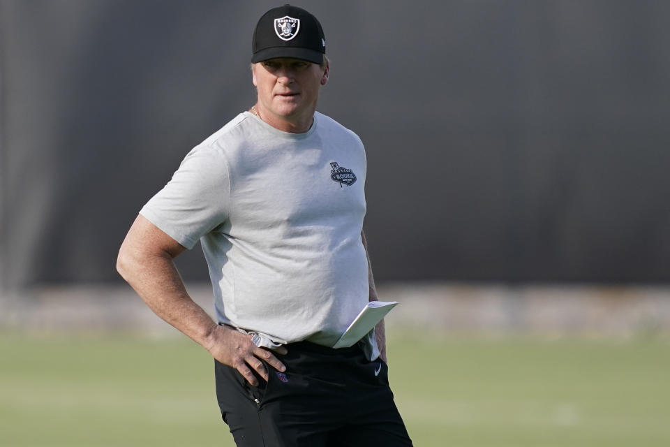 FILE - Las Vegas Raiders head coach Jon Gruden looks on during an NFL football practice in HNenderson, Nev., in this Tuesday, June 15, 2021, file photo. Gruden and the Raiders were fined a total of $650,000 and docked a sixth-round draft pick for repeated violations of the NFL’s COVID-19 protocols. (AP Photo/John Locher, File)