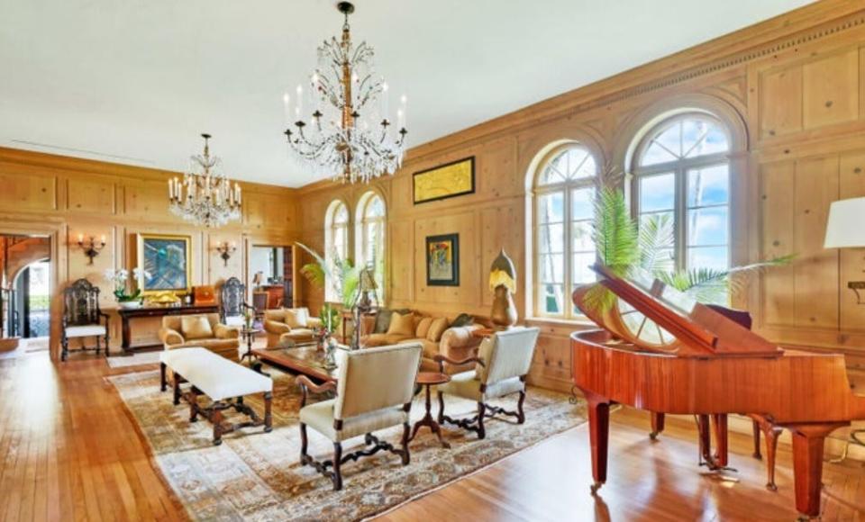 The restored living room of the 1920s-era house at 930 S. Ocean Blvd. in Palm Beach features paneling and hardwood floors.