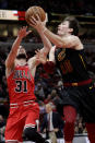 Cleveland Cavaliers forward Cedi Osman, right, shoots next to Chicago Bulls guard Tomas Satoransky during the second half of an NBA basketball game in Chicago, Saturday, Jan. 18, 2020. (AP Photo/Nam Y. Huh)