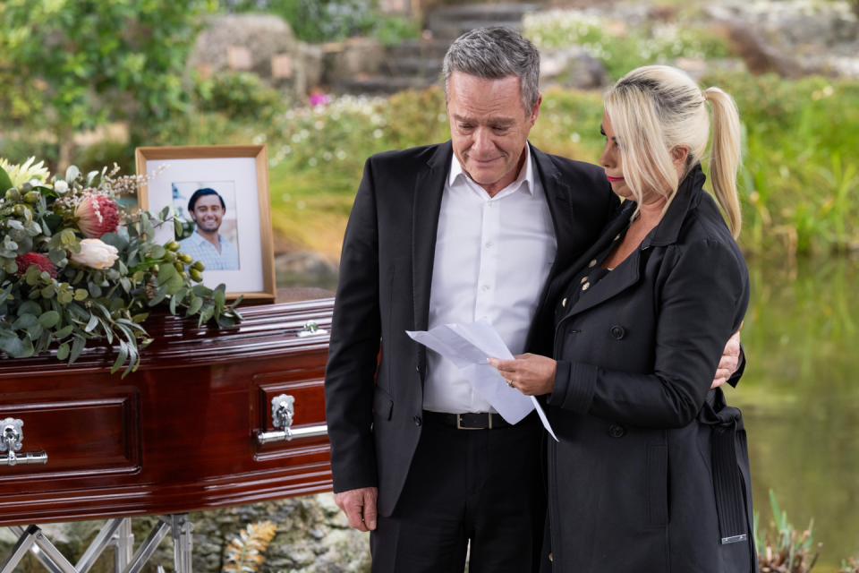 paul robinson and lucy robinson at david tanaka's funeral in neighbours