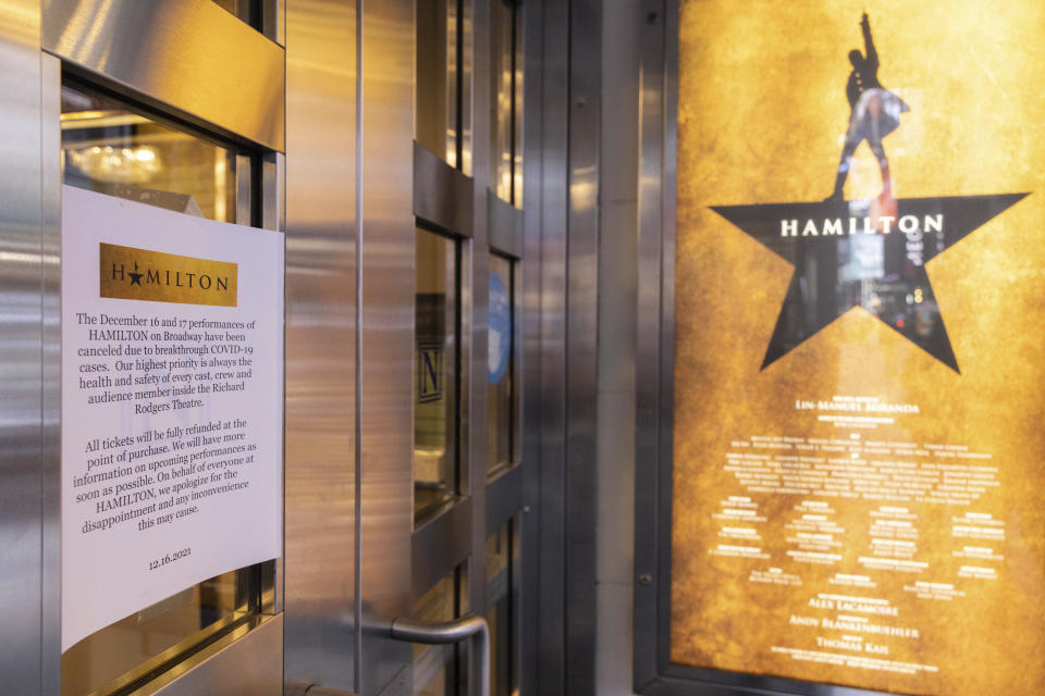 A poster explaining the cancellations of the Hamilton broadway shows due to COVID-19 cases at the Richard Rodgers Theatre on Friday, Dec. 17, 2021, in New York. New York City had been mostly spared the worst of the big surge in COVID-19 cases that has taken place across the northeastern and midwestern U.S. since Thanksgiving, but the situation has been changing rapidly in recent days. (AP Photo/Yuki Iwamura)