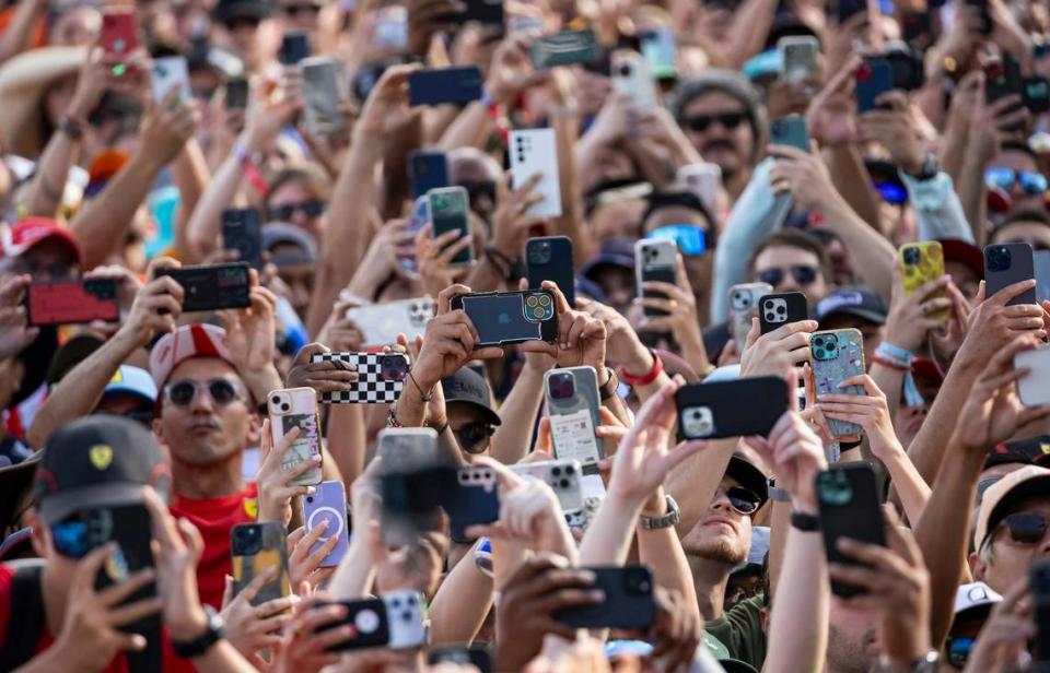 Fans use their phones as McLaren driver Lando Norris of Britain takes the podium after winning the Formula One Miami Grand Prix at the Miami International Autodrome.
