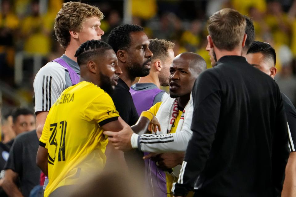 Jul 8, 2023; Columbus, Ohio, USA;  Columbus Crew defender Steven Moreira (31) and midfielder Darlington Nagbe (6) hold back head coach Wilfried Nancy during the second half of the MLS soccer match at Lower.com Field. The Crew tied 1-1.
