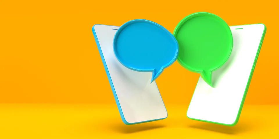 Green and blue texting bubbles on two smartphones representing Android and iPhones' iMessage