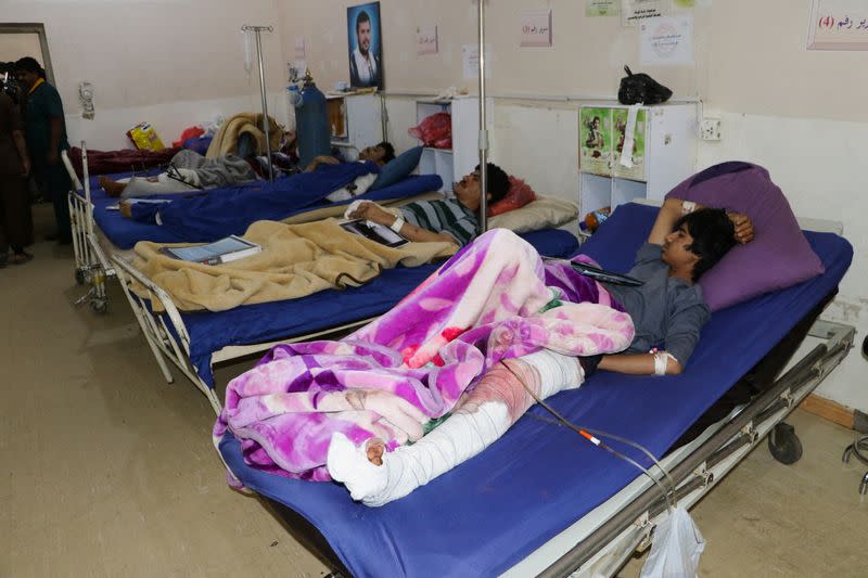 People injured by air strikes on a detention center lie on hospital beds in Saada