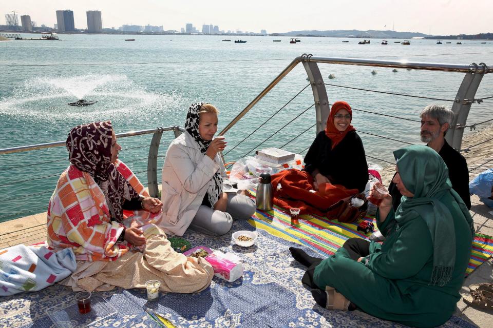 Iranians spend time outdoors observing the ancient festival of Sizdeh Bedar, an annual public picnic day on the 13th day of the Iranian New Year, west of Tehran, Iran, Wednesday, April 2, 2014. Sizdeh Bedar, which comes from the Farsi words for “thirteen” and “day out,” is a legacy from Iran’s pre-Islamic past that hard-liners in the Islamic Republic never managed to erase from calendars. Many say it’s bad luck to stay indoors for the holiday. (AP Photo/Ebrahim Noroozi)