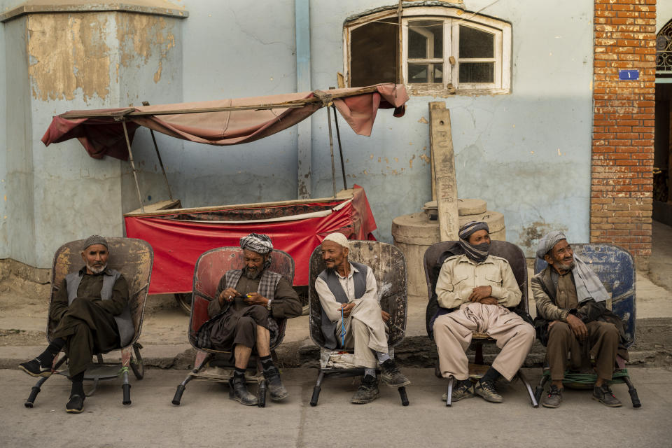 Laborers wait in the street to be hired in Kabul, Afghanistan, Sunday, Sept. 12, 2021. (AP Photo/Bernat Armangue)