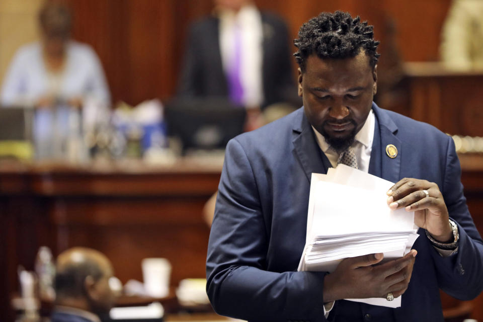 South Carolina state Rep. Jermaine Johnson, D-Columbia, looks through a stack of amendments before the House restarted its debate on an abortion bill, Wednesday, May 17, 2023, in Columbia, S.C. (AP Photo/Jeffrey Collins)