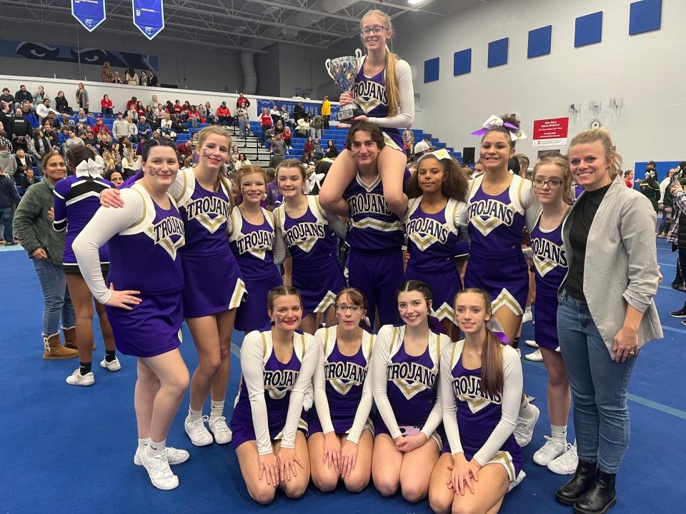Sebring senior cheerleader Johnathon Billingsley, center, who began his cheerleading career as a junior, plans to continue his career starting in Fall 2024 at University of Cincinnati. Sebring's team is coached by Cassy Wynn, right.