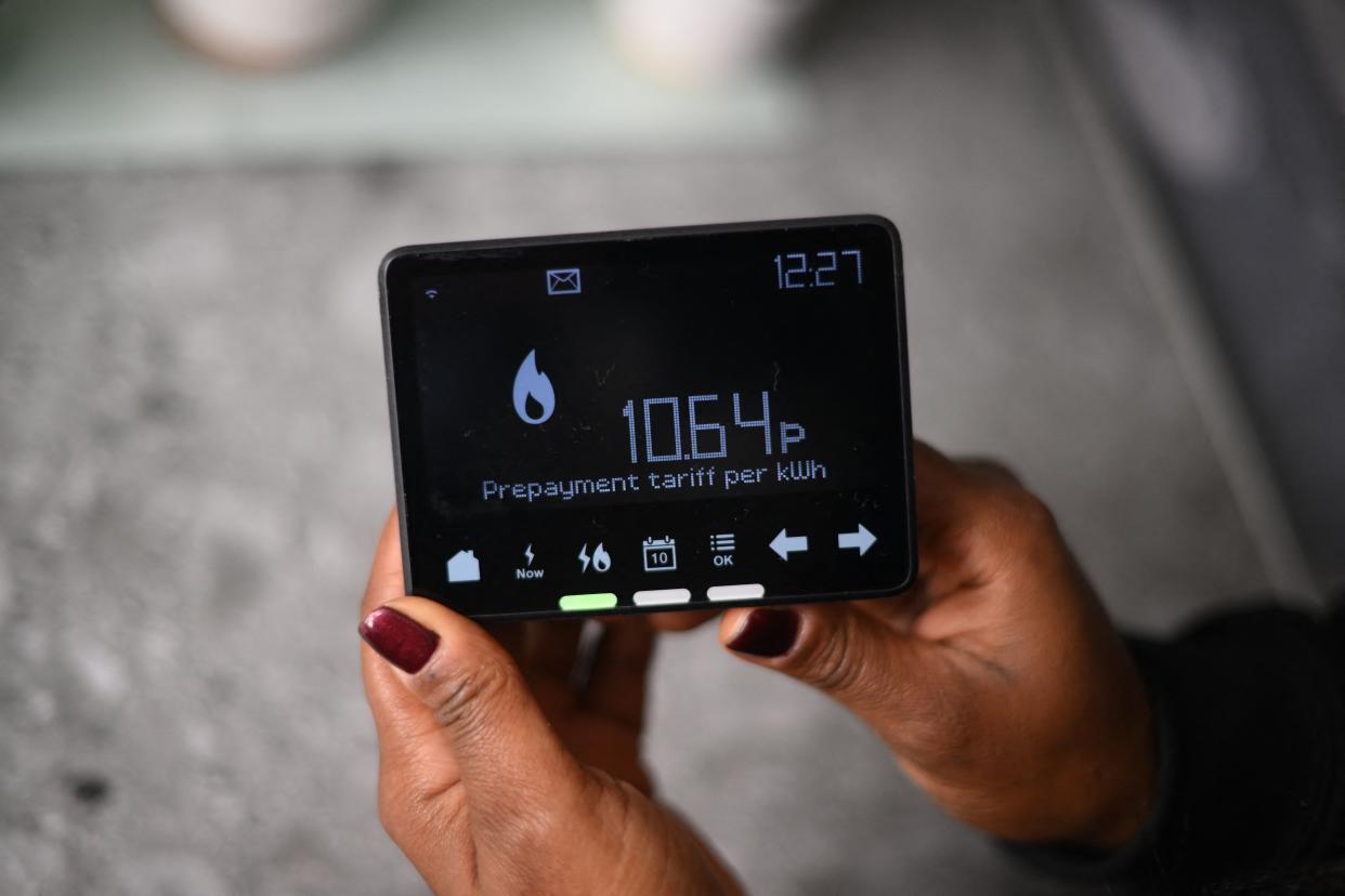 Samantha Pierre-Joseph shows her smart meter indicating that she is on a 'Prepayment tariff', in her house in London, on December 13, 2022. - Pierre-Joseph, 40, who lives with her grown-up daughter, was recently switched to a prepay meter by her supplier. She now pays more for electricity and gas than the old direct-debit payment system to heat her house, worsening the cost-of-living crisis as prices of food and other essentials also soar. (Photo by Daniel LEAL / AFP) (Photo by DANIEL LEAL/AFP via Getty Images)