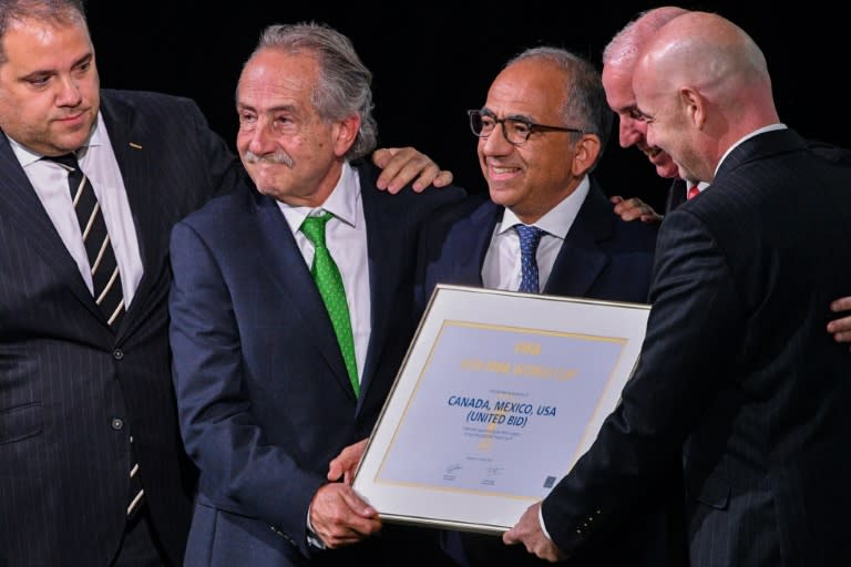 North American bid leaders Carlos Cordeiro (centre) and the president of the Mexican Football Association Decio de Maria Serrano (2nd L) celebrate after they won the right to host the 2026 World Cup