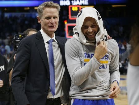 Jan 22, 2017; Orlando, FL, USA; Golden State Warriors head coach Steve Kerr reacts with guard Stephen Curry (30) after they beat the Orlando Magic at Amway Center. Golden State Warriors defeated the Orlando Magic 118-98. Mandatory Credit: Kim Klement-USA TODAY Sports