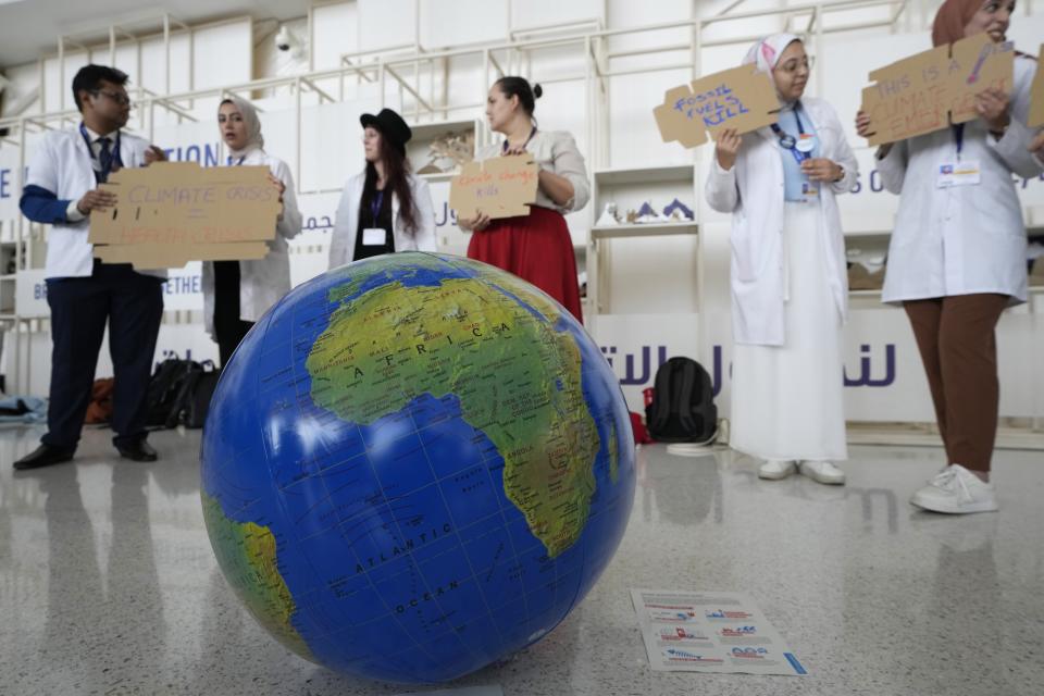 People participate in a demonstration to highlight the link between health and climate at the COP28 U.N. Climate Summit, Sunday, Dec. 3, 2023, in Dubai, United Arab Emirates. (AP Photo/Peter Dejong)