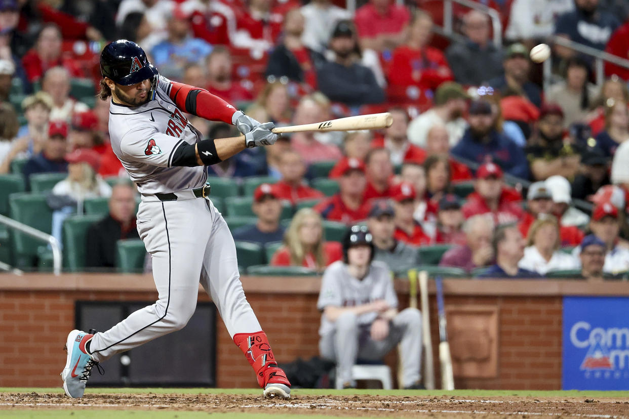 Arizona Diamondbacks' Eugenio Suarez hits an RBI ground rule double during the fifth inning of a baseball game against the St. Louis Cardinals, Monday, April 22, 2024, in St. Louis. (AP Photo/Scott Kane)